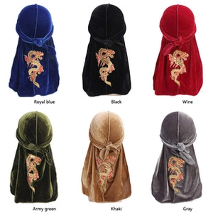 Detail showing six velvet durags with intricate gold dragon embroidery in various colors