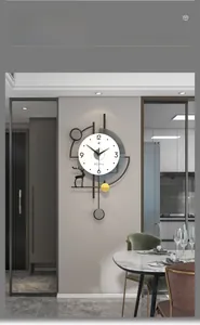 Detail of modern minimalist wall clock with a gold pendulum and artistic deer silhouette