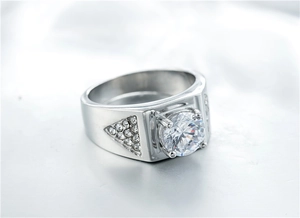 Macro detail of men's wedding ring featuring a large round zircon and side pavé settings