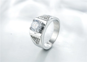 Macro shot of silver ring with large round solitaire zircon and geometric side accents