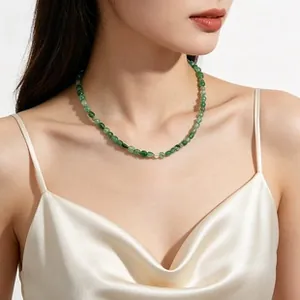 Choker style necklace featuring irregular green translucent aventurine beads on model