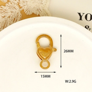 Close-up macro detail of a gold heart-shaped lobster clasp with dimensions 26mm x 15mm