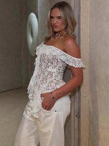 Elegant white lace off-shoulder top with ruffled neckline and sheer floral patterns