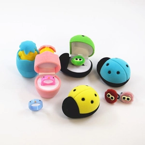 Macro detail of various colorful flocked strawberry and animal jewelry boxes for rings