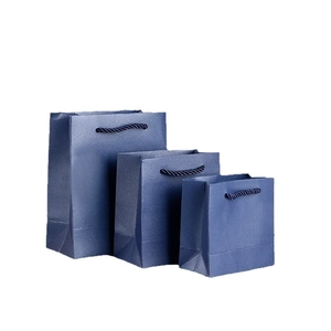 Three premium blue pearlescent paper gift bags with twisted handles in tiered sizes