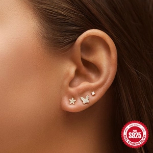 Macro view of S925 sterling silver mini star, butterfly, and round zircon stud earring set