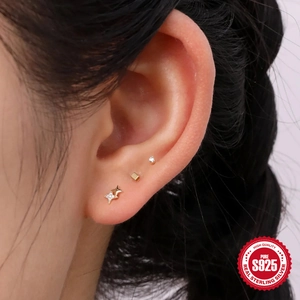 Close-up of minimalist S925 sterling silver gold stud set featuring zircon star and cube