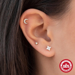 Detailed view of S925 sterling silver ear studs set with moon and flower zircon on ear