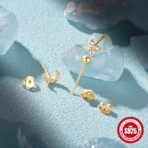 Macro detail of S925 sterling silver mini earring set with zircon floral and moon shapes