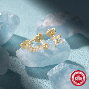 Macro shot of S925 sterling silver moon and flower earrings with zircon on blue crystal