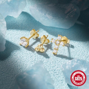 Detailed macro view of S925 sterling silver gold plated stud earrings with zircons
