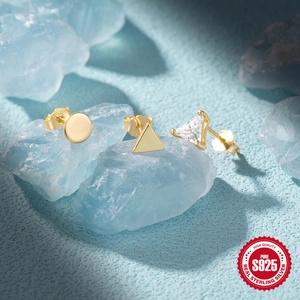 Detailed view of S925 sterling silver stamp on minimalist gold geometric stud earrings