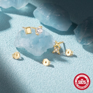 Detailed macro view of S925 sterling silver gold-plated stud earrings with zircon stones