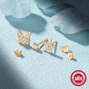 Macro shot of S925 sterling silver gold stud set featuring butterfly, star and zircon