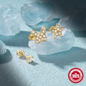 Detailed macro view of S925 sterling silver butterfly and star stud earrings set