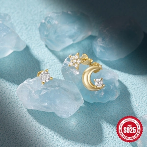 Detail of S925 sterling silver gold moon and star stud earrings set with zircons