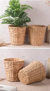 Detail of handcrafted woven storage baskets showing natural fiber texture and plant decor