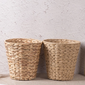 Set of two handmade woven grass storage baskets in natural brown for home decor