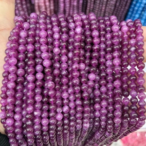 Close-up of polished purple chalcedony round beads for DIY jewelry making and crafts