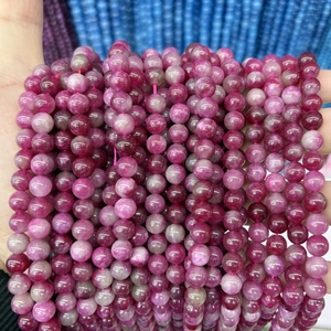 Macro shot of polished translucent purple chalcedony round beads for jewelry making