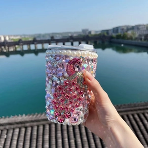 Detailed shot of handmade rhinestone peacock thermos with pearls in pink-purple gradient
