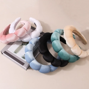 Close-up of colorful sponge headbands showing textured fabric and wave-like bubble design