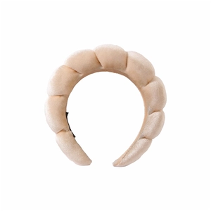 Detailed view of beige velvet braided headband with thick padded design for volume
