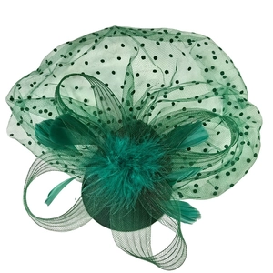 Detailed close-up of dark green mesh fascinator with black dots and emerald feathers