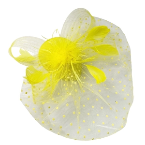 Detail of yellow fascinator hat with polka dot mesh netting, feathers and a bow decoration