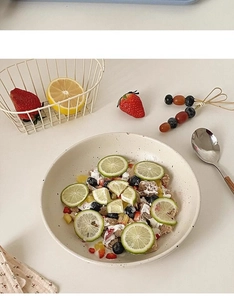 Japanese ceramic salad bowl with ink splash pattern filled with fresh berries and grains