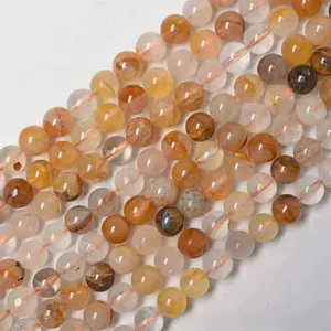 Détail macro de perles de quartz hématitique naturel avec des inclusions minérales orange