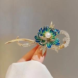 Elegant gold flower hair clip with teal enamel petals, white pearl and sparkling crystals