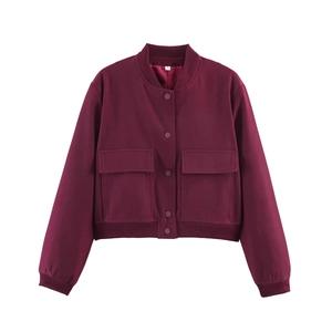 Detailed shot of burgundy bomber jacket featuring large pockets and snap button closure