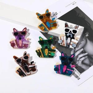 Macro detail of acrylic dog pins with marble textures and sleek sunglasses design