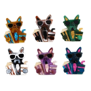 Detailed close-up of colorful acrylic bulldog pins featuring sunglasses and popcorn