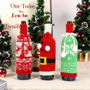 Drei gestrickte Weinflaschenhüllen zu Weihnachten mit Rentier-, Nikolaus- und Schneeflocken