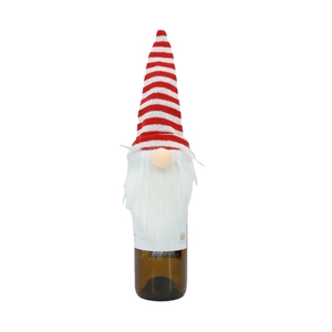 Close-up of Christmas gnome wine bottle cover with red striped knitted hat and white beard