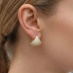 Elegant gold fan-shaped stud earrings with pave diamond inlay shown on a model