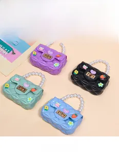 Close-up of quilted mini bags with pearl handles and cute cartoon strawberry charms