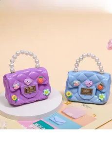 Close-up of DIY jelly crossbody bags with pearl handles and cute cartoon charms