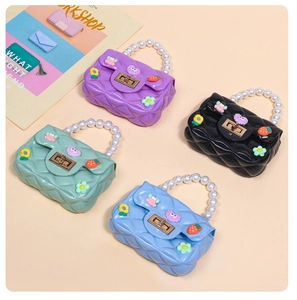 Detail of four colorful mini jelly purses with pearl handles and cute cartoon charms