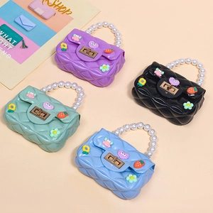 Mini jelly crossbody bags with pearl handles and cute cartoon charms in four bright colors