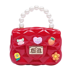 Red kids jelly handbag with pearl handle and cartoon charms in quilted pattern design