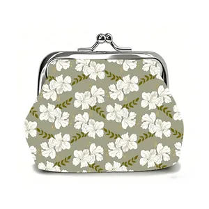 Close-up of vintage kiss-lock coin purse featuring white floral patterns on a sage green base