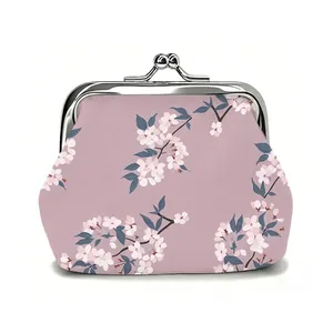 Detail view of pink kiss-lock coin purse with white cherry blossom prints and metal clasp