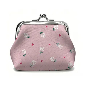 Close-up of vintage pink floral coin purse with silver metal clasp and heart pattern