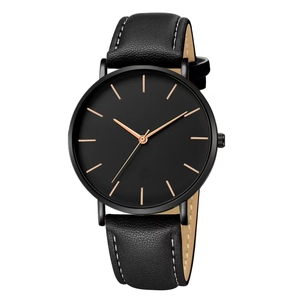 Minimalist black quartz watch featuring rose gold markers and a textured leather strap