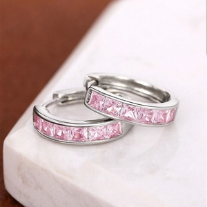 Elegant silver earrings featuring square-cut pink zircon stones in a huggie hoop design