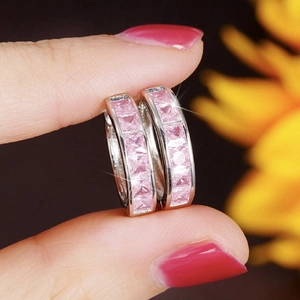 Sparkling silver huggie earrings featuring square-cut pink zircons in a micro-pave setting