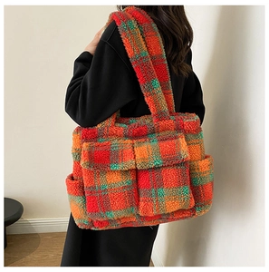 Detail of colorful plaid teddy fleece tote bag with dual front pockets on model